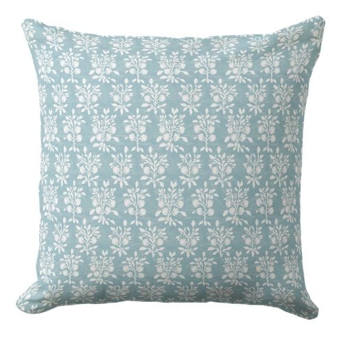 A coastal throw pillow featuring An ornate coastal hand block style floral print in light blue and white