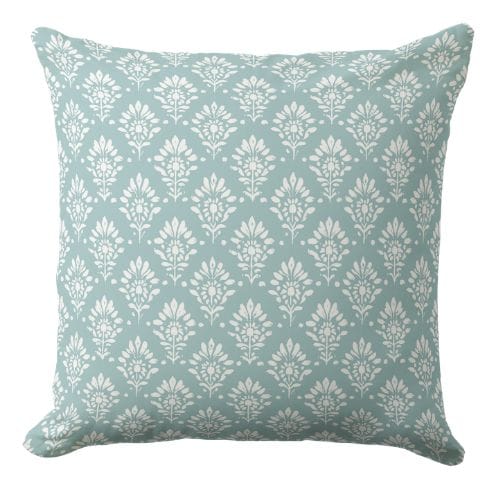 A blue and white throw pillow in a modern coastal style.