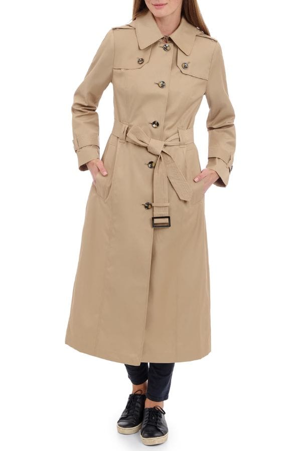 This women's trench coat features a classic button-front design for a sophisticated look and ideal for any wardrobe