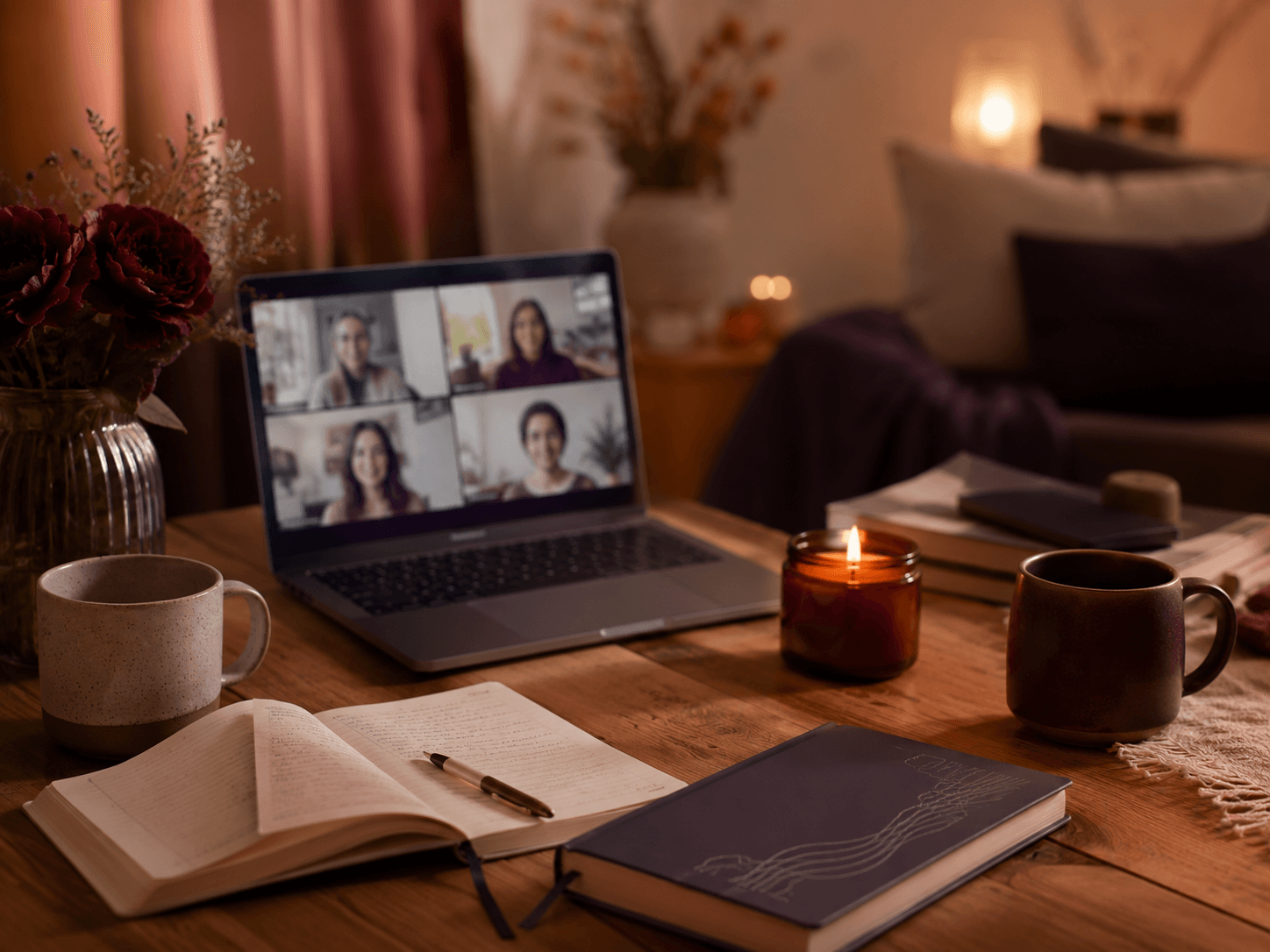 Cozy gathering space with journals, candles, mugs, and a warm setup for reflection and community