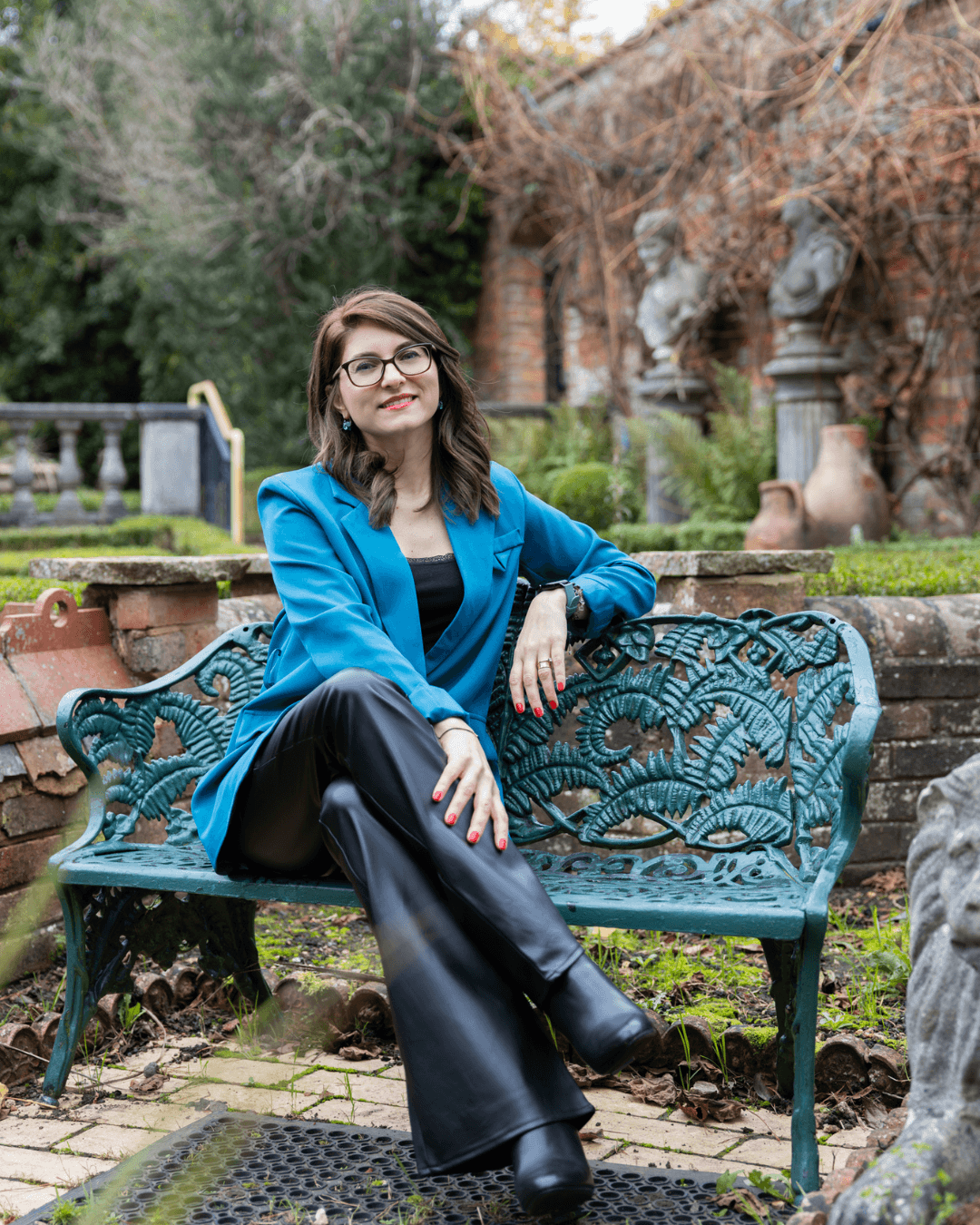 Viviana Apiok sitting in a garden, reflecting on alignment and inner clarity