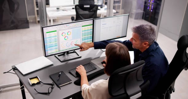 Billing team reviewing claims and reports on screen