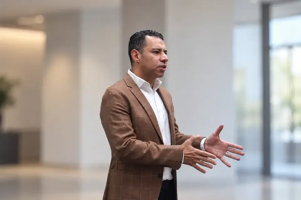 Ahmad Haikal speaking in a brown checked jacket