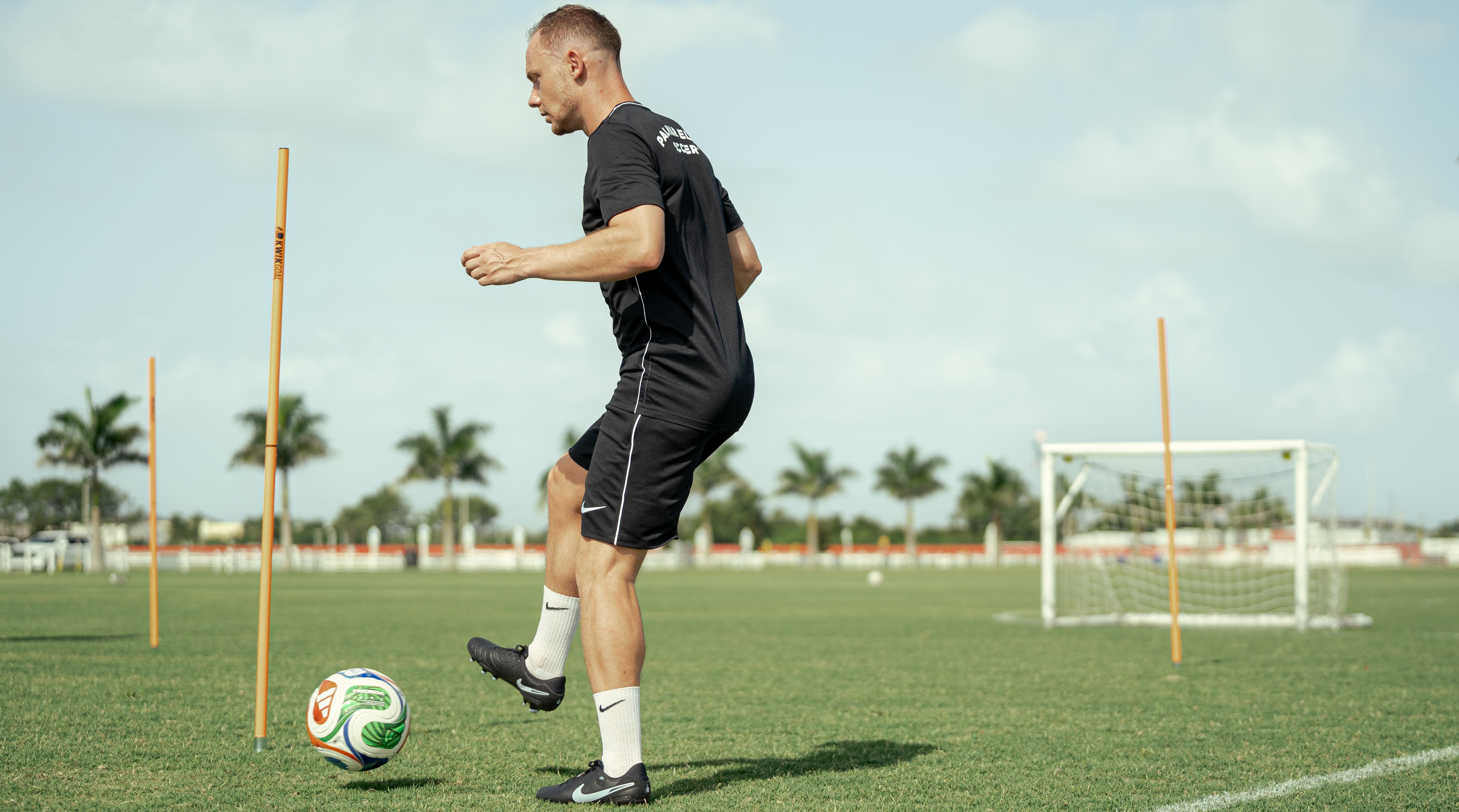 Federico playing with the ball on a soccer field.