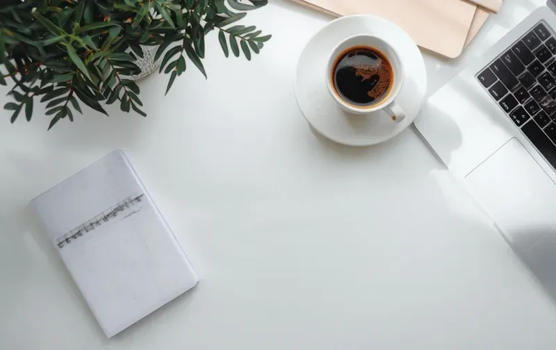 A calm desk with a laptop and notebook