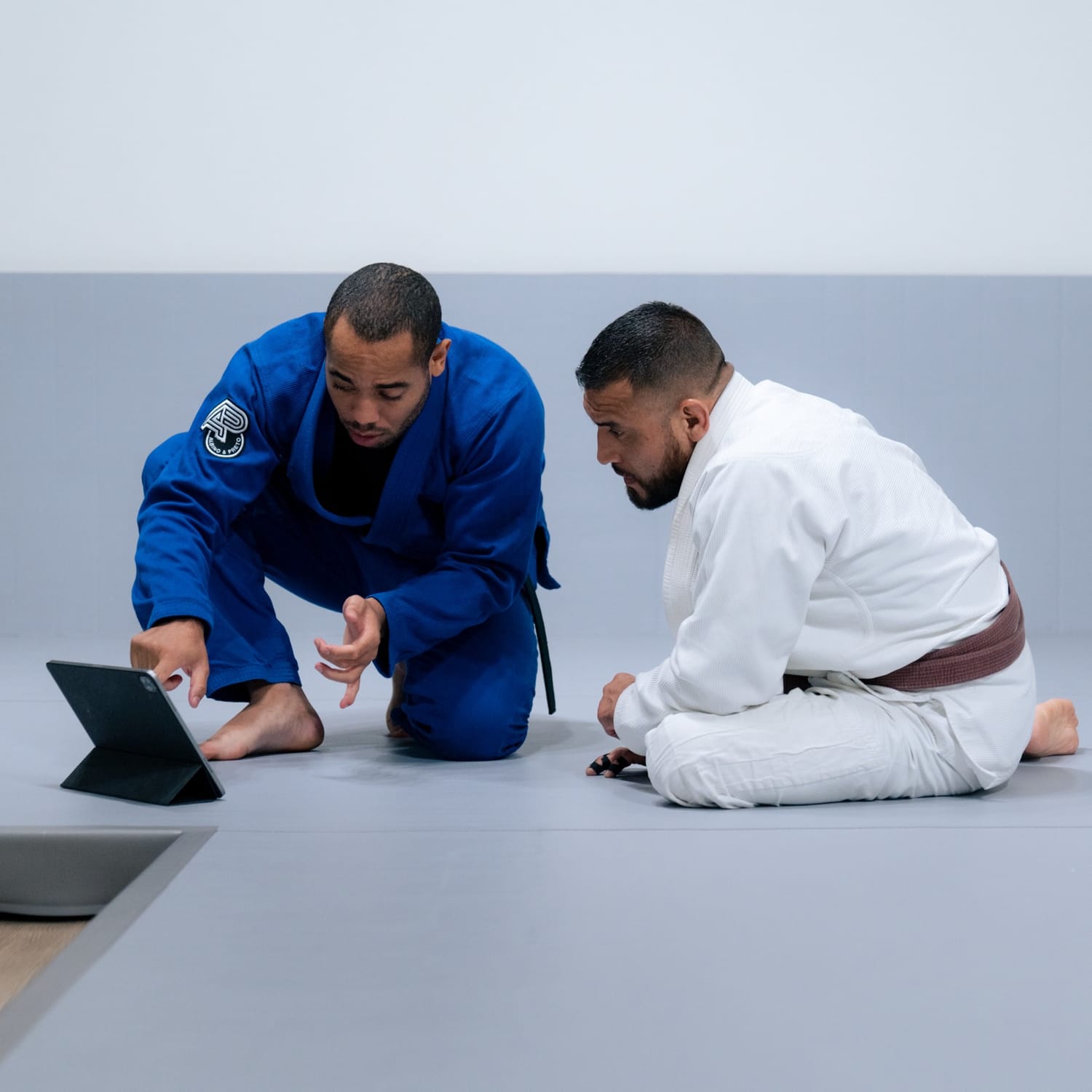 Johnatha reviewing training footage on a tablet with a student