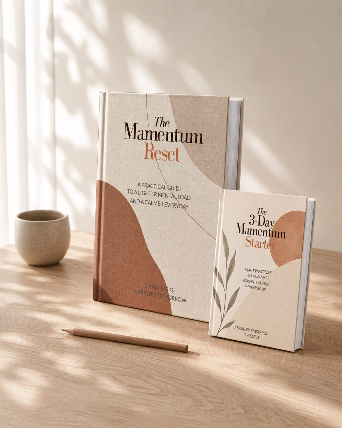 The Mamentum Reset and 3-Day Mamentum Starter guides on a pale oak table