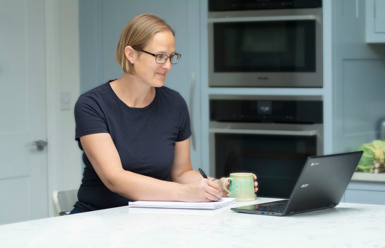 Kathryn working at her kitchen table