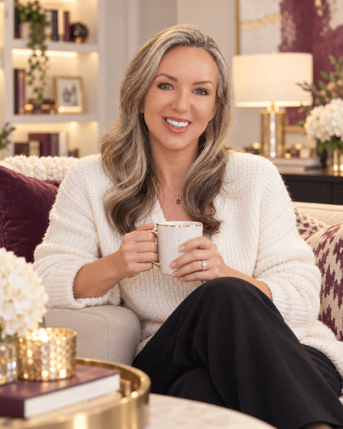 Lucy Gilmour smiling over a cup of tea at home