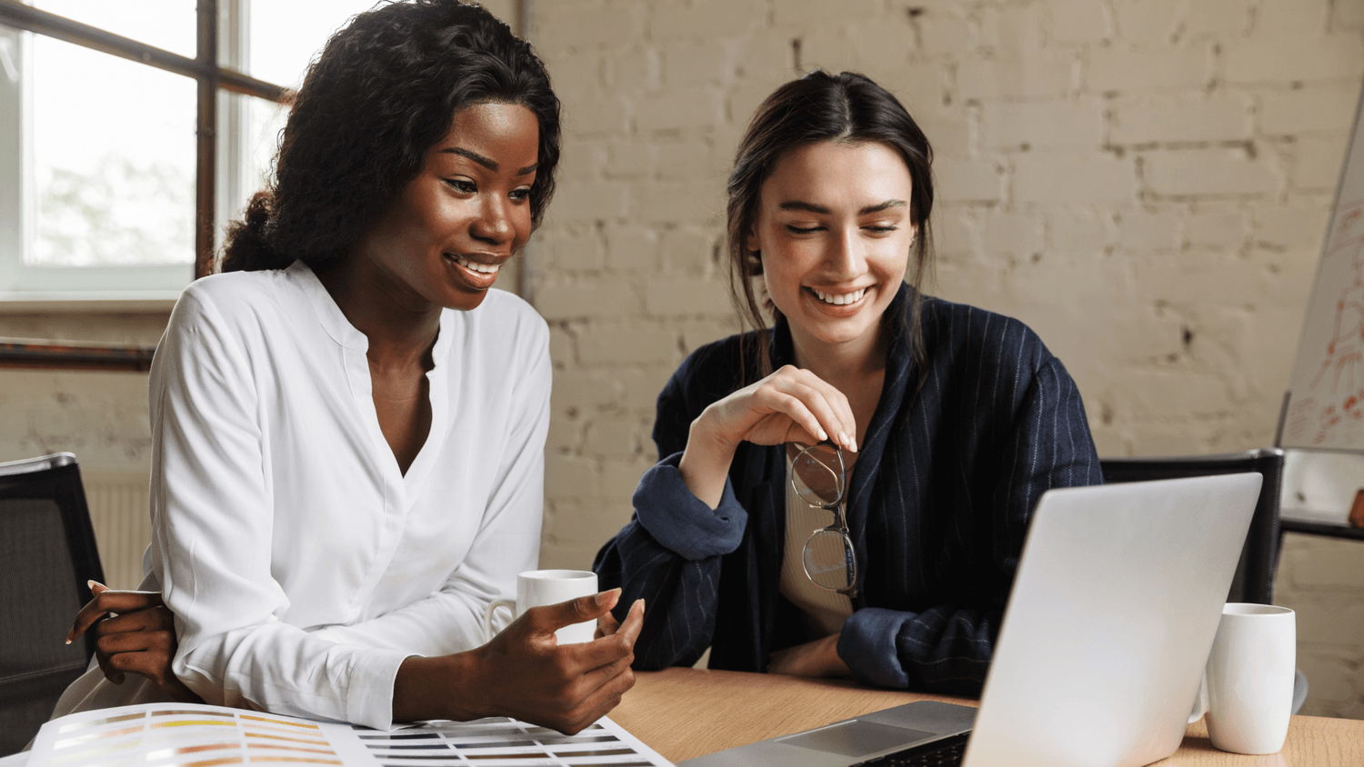 two women looking at laptop