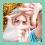 A woman making a square frame around her eyes with her hands