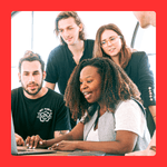 four people looking at laptop