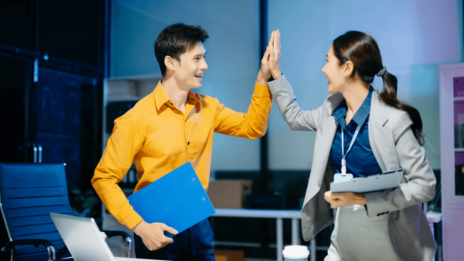 a man and a woman hi-fiving