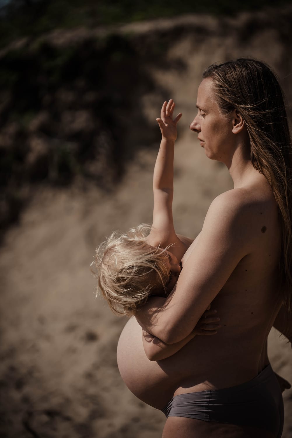 pregnant woman hands on belly soft natural light