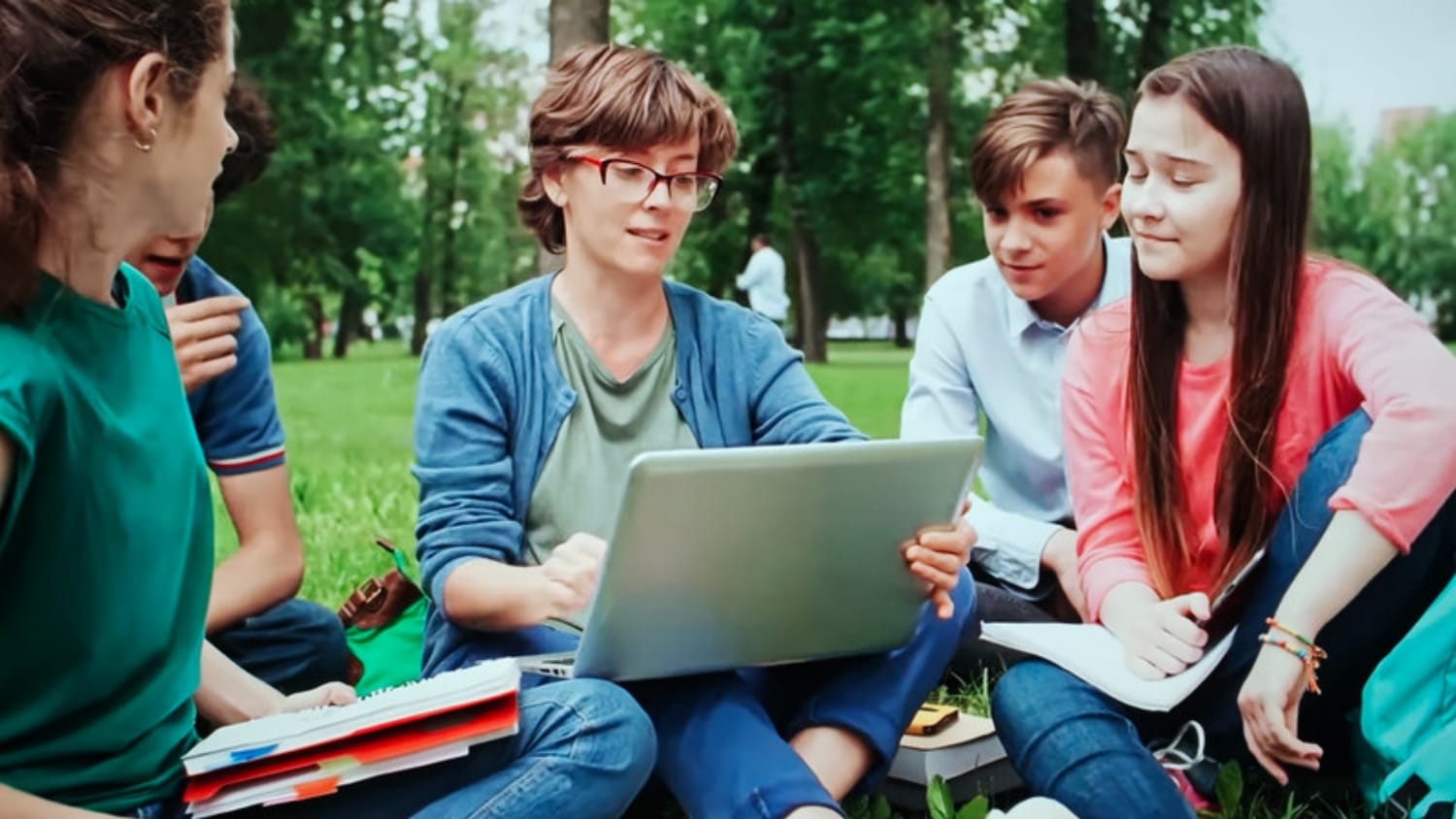 Group of students studying together with a laptop in a small group lesson
