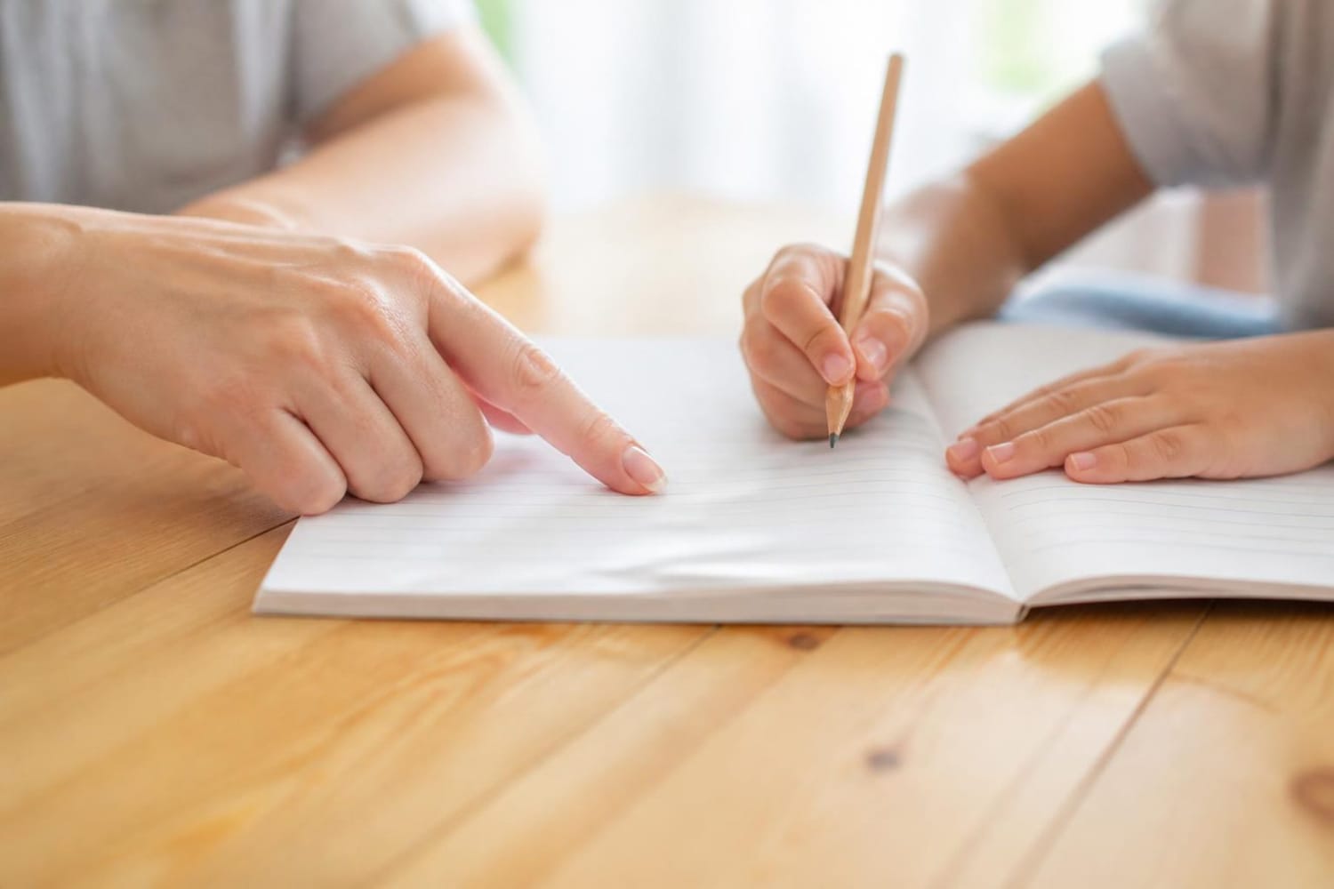 Tutor and learner working through a notebook together
