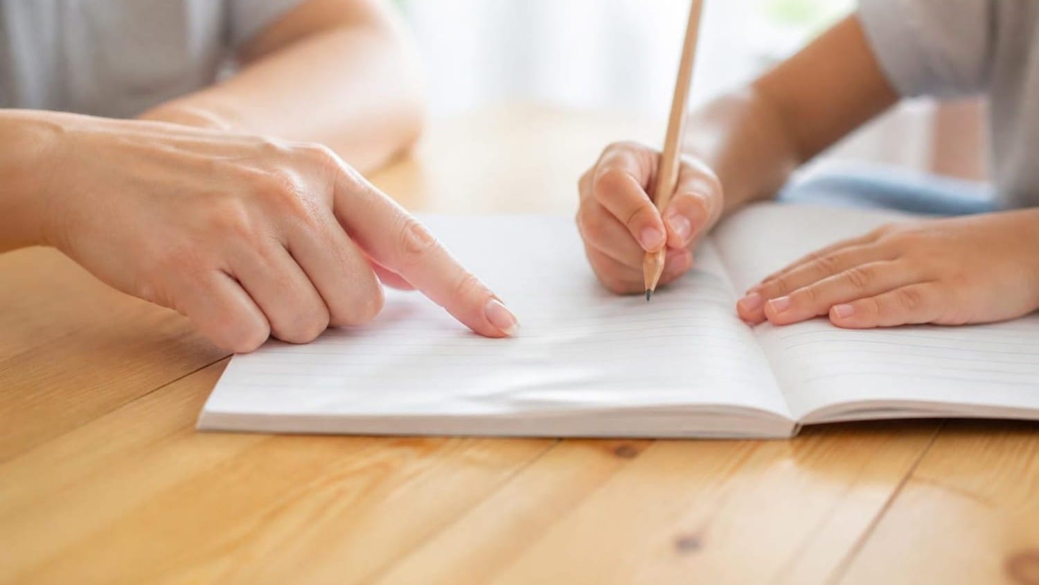 Tutor and learner working through a notebook together