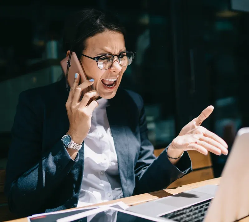 Professional woman feeling overwhelmed during a difficult call