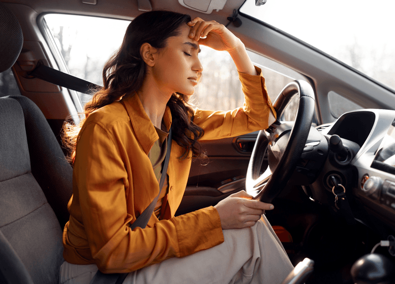 Woman taking a moment to calm herself in her car