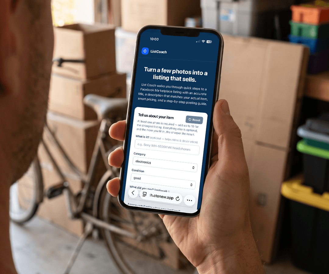 Someone holding a phone showing List Coach, standing in a garage with boxes and a bike ready to sell.