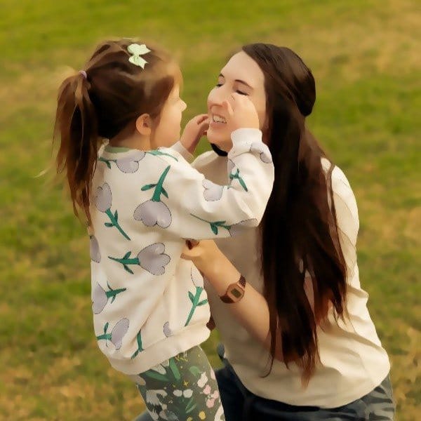 Jess laughing with her daughter outdoors