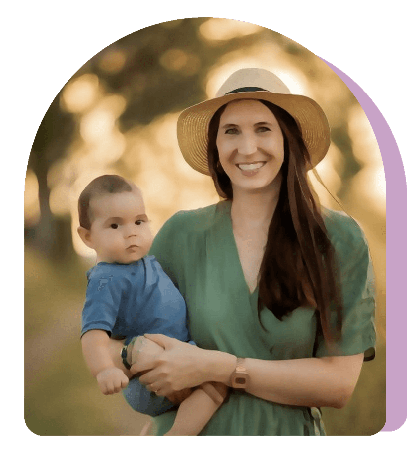 Jess in a sun hat holding her toddler