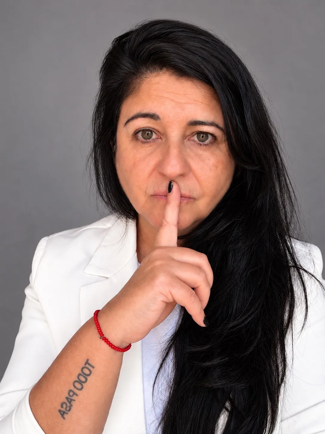 Adriana Graziano haciendo el gesto de silencio con el dedo sobre los labios