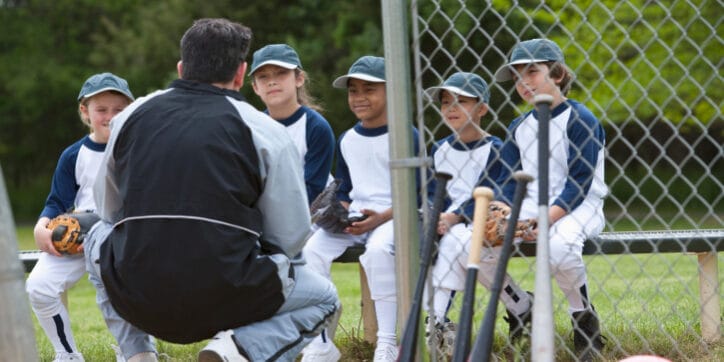 Coach with youth baseball players