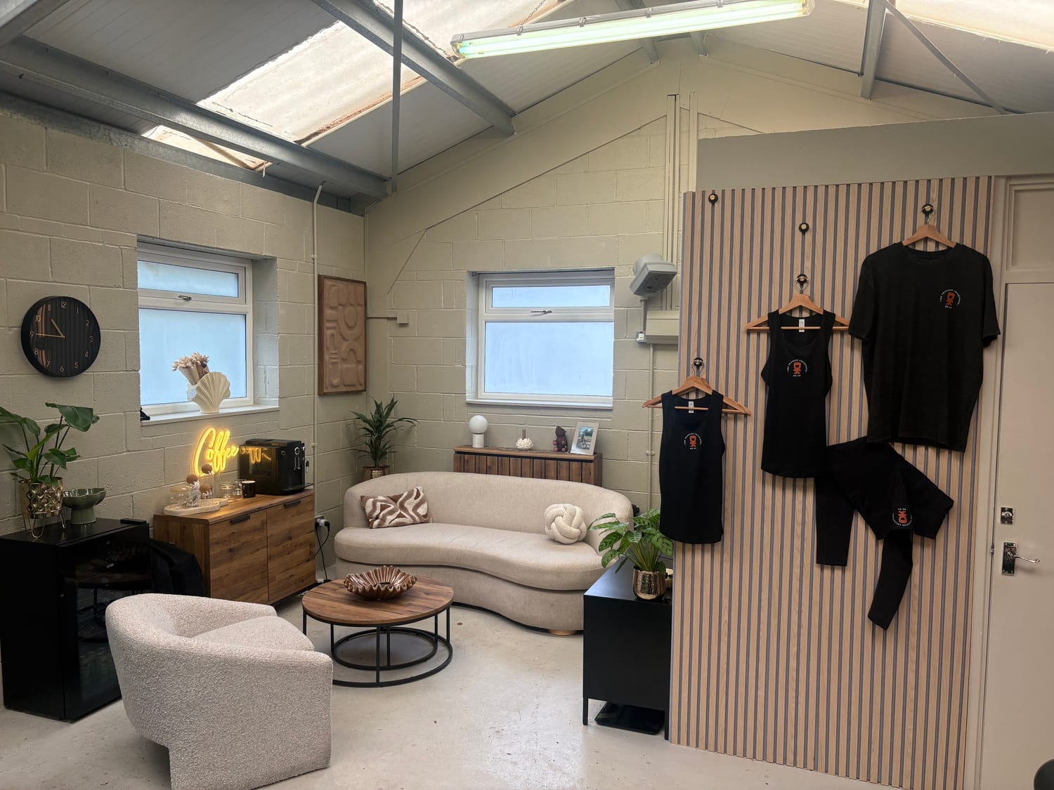 The community area - sofa, coffee machine, oak panelling and plants