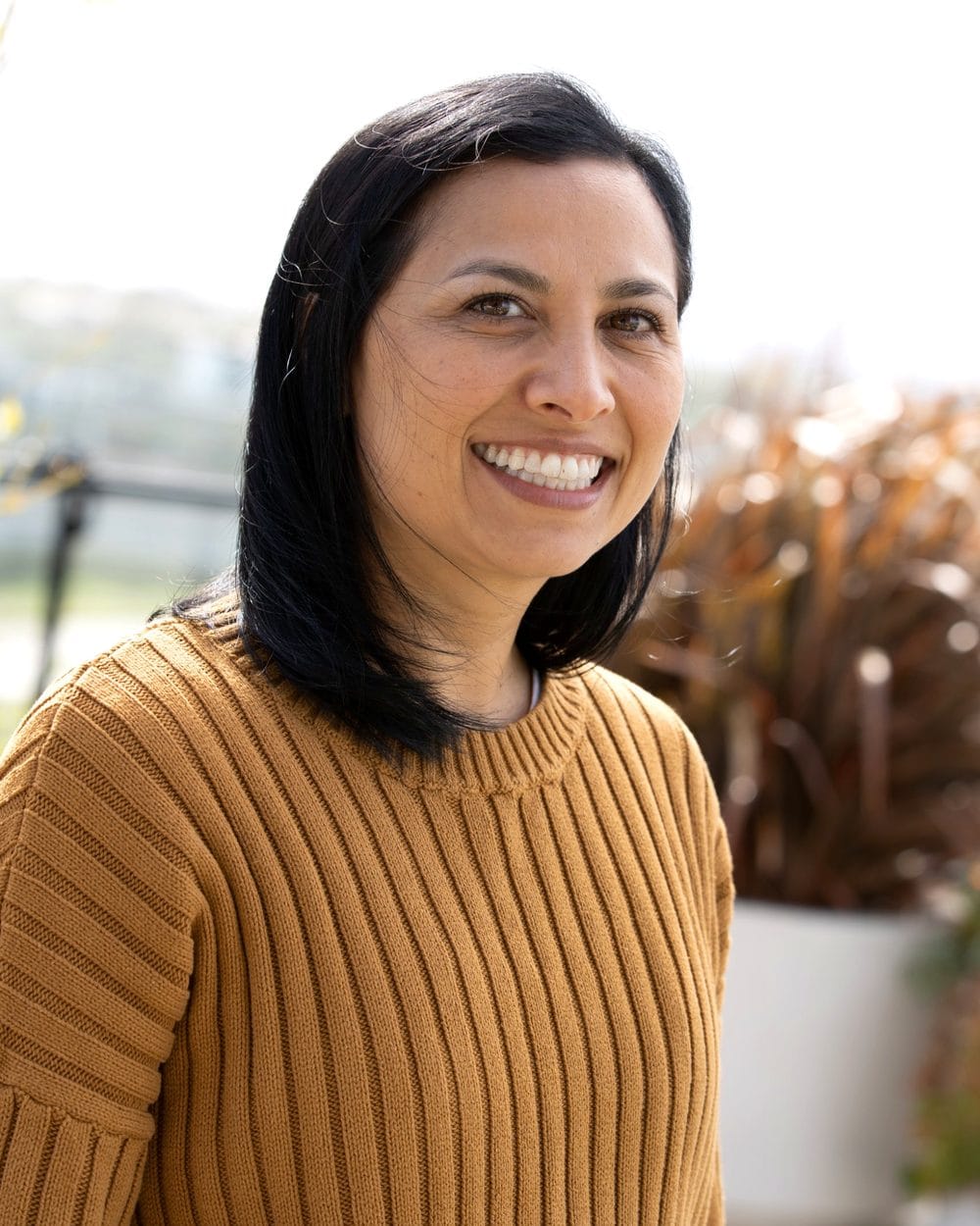 Sol, founder of Home Wellness Organisers, smiling outdoors
