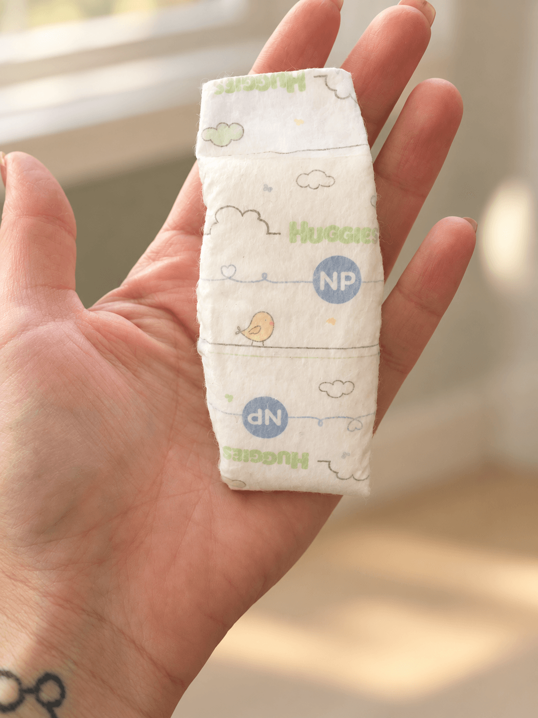 AI-edited version of Kelli’s photo of a tiny premature-size diaper resting in her hand