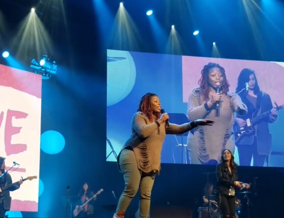 Estee Marie on Stage with May Tangeles performing at he BRAVE conference