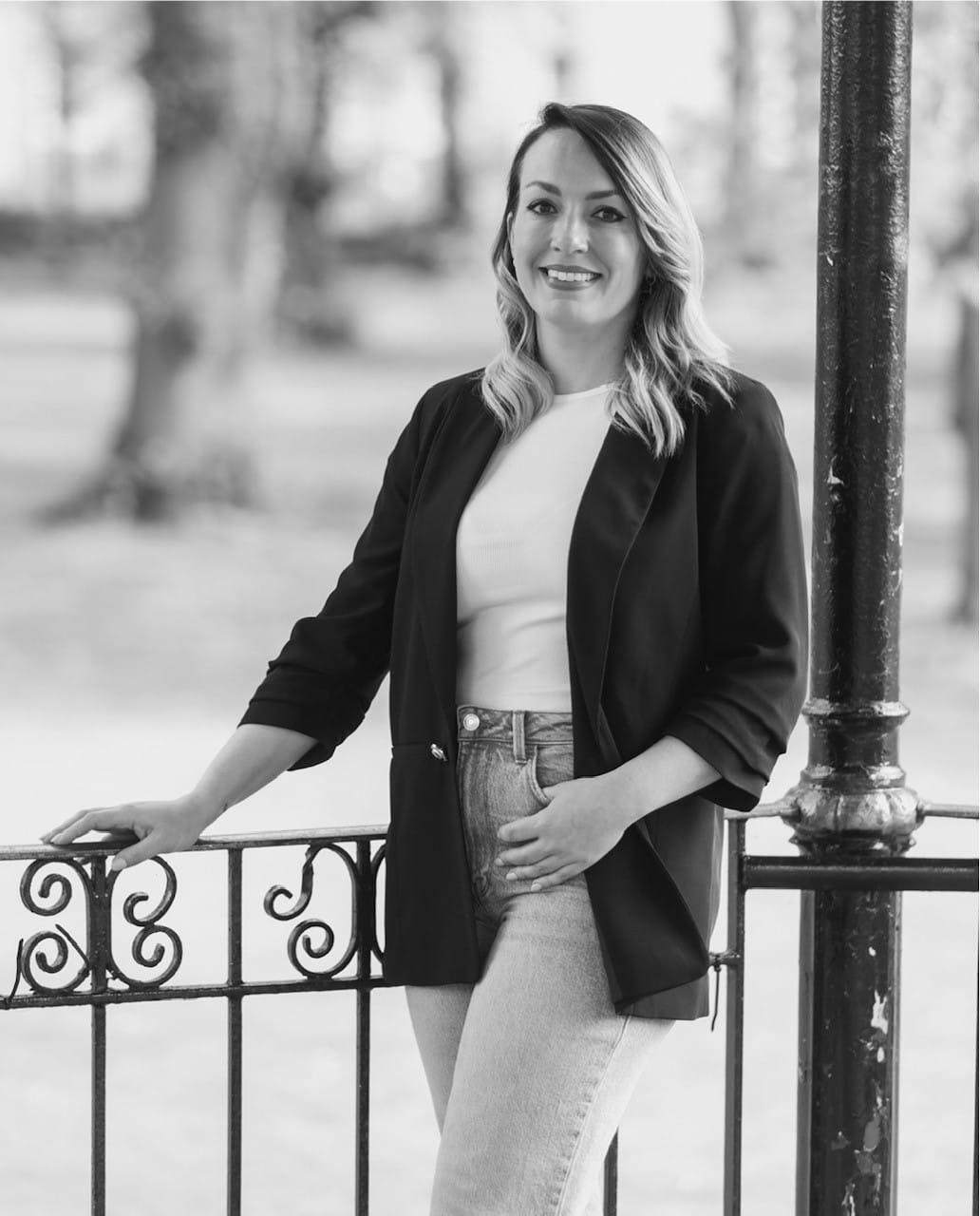 Black and white portrait of Lauren Bell in a park bandstand