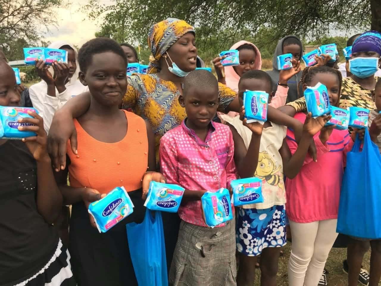 Girls receiving sanitary pads at an outreach day