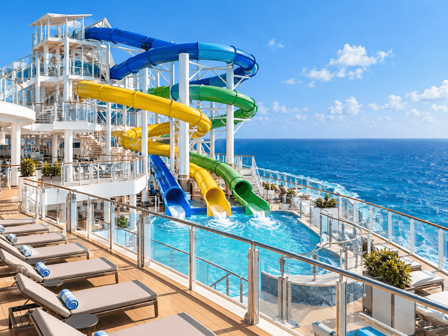 Colorful waterslides on a cruise ship top deck overlooking the ocean