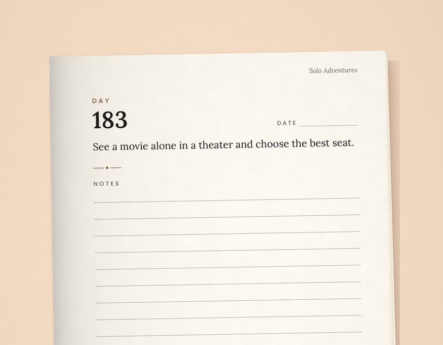 Day 183 page from The Solo Year paperback: See a movie alone in a theater and choose the best seat.