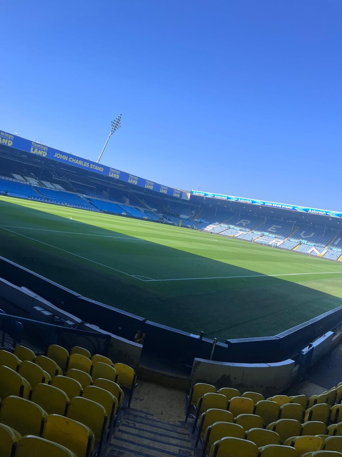 A sunny view across the Elland Road pitch towards the John Charles and Don Revie stands.