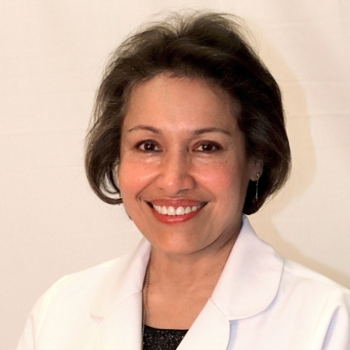 women wearing white doctor's coat smiling