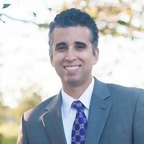 man wearing blue suit smiling