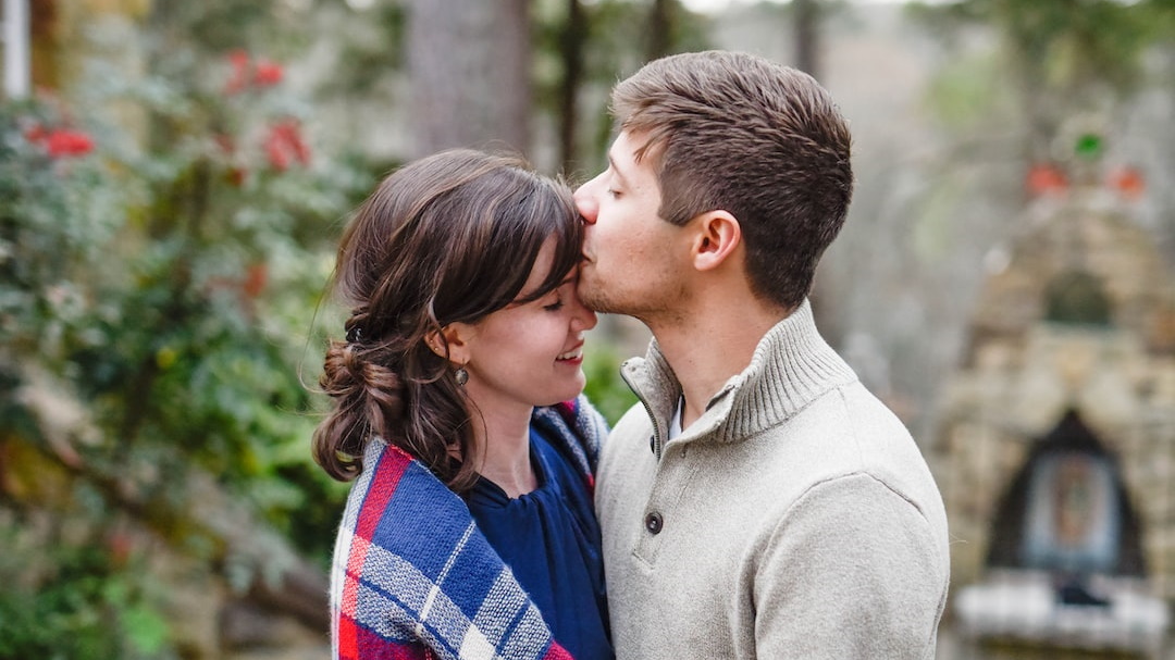 Man Kissing Woman on Forehead