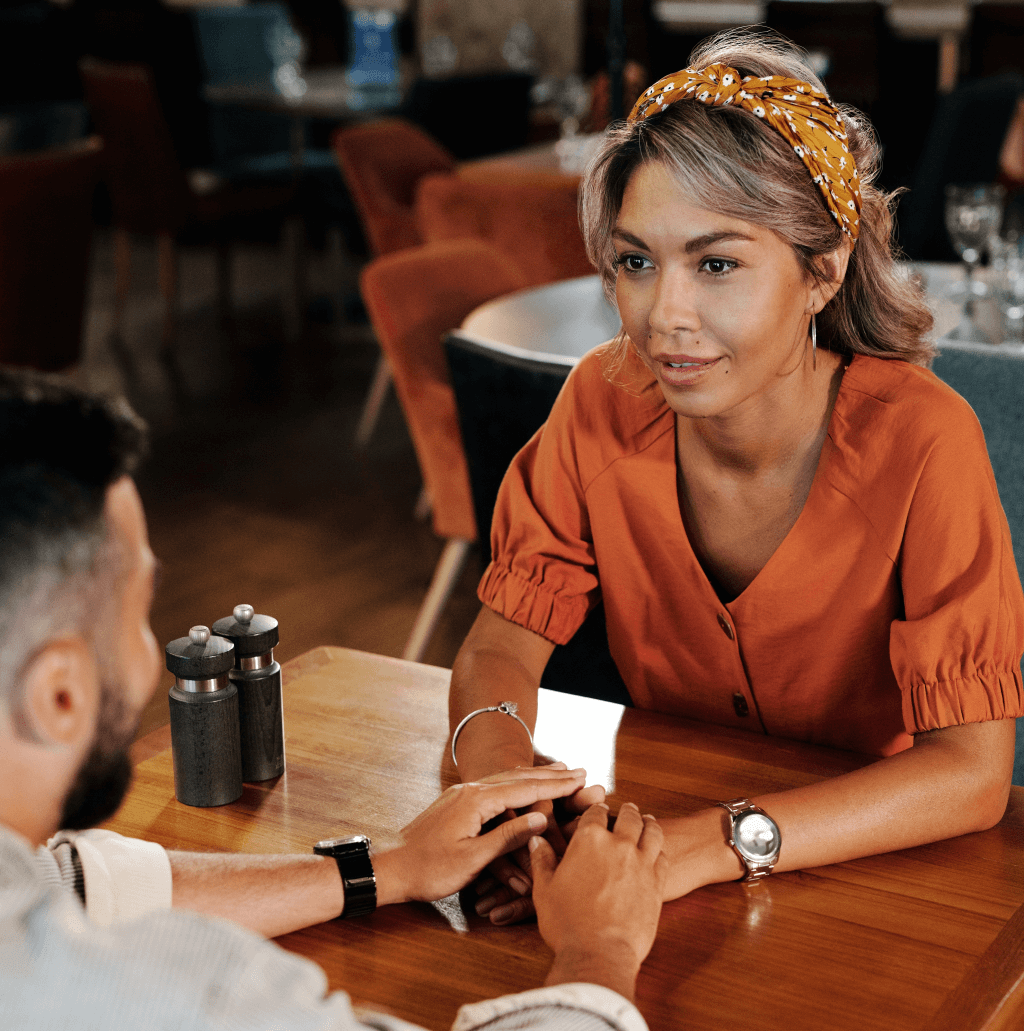 Woman holding hand with man