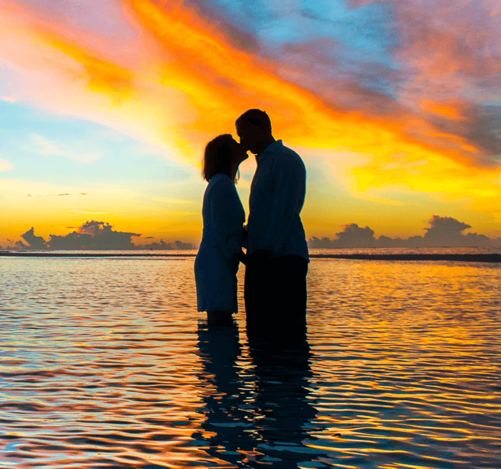 Couple kissing in sunset on beach