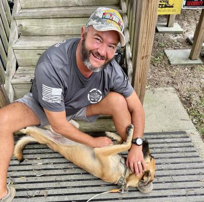 Image of a man enjoying with his dog telling how great he feels because of the perfect pack