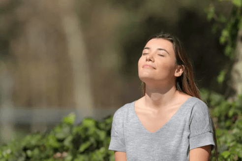 A peaceful person meditating in a calm nature setting managing anxiety and depression naturally using CBD isolate for emotional well-being.