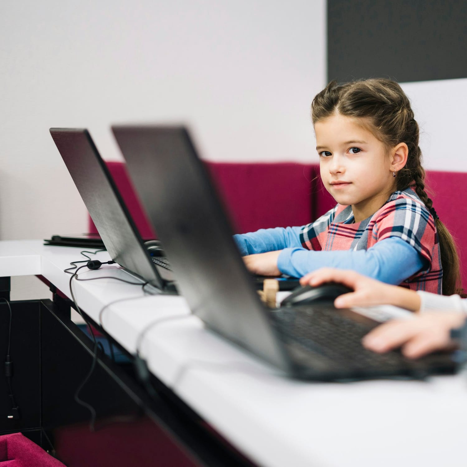 A smiling student engaging in a vibrant online STEM classroom environment — online coding course