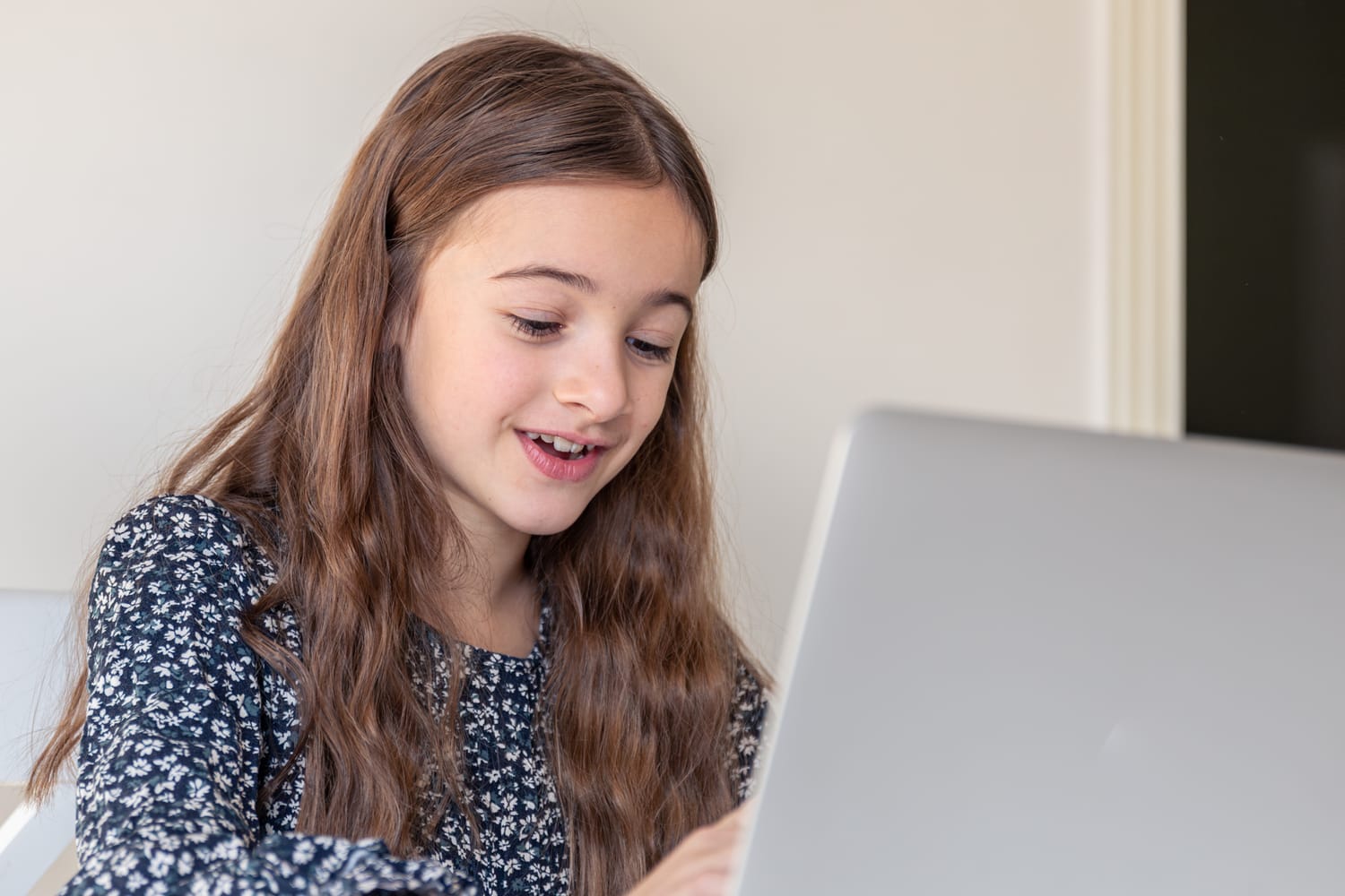 Child confidently working on coding project - online coding course for kids