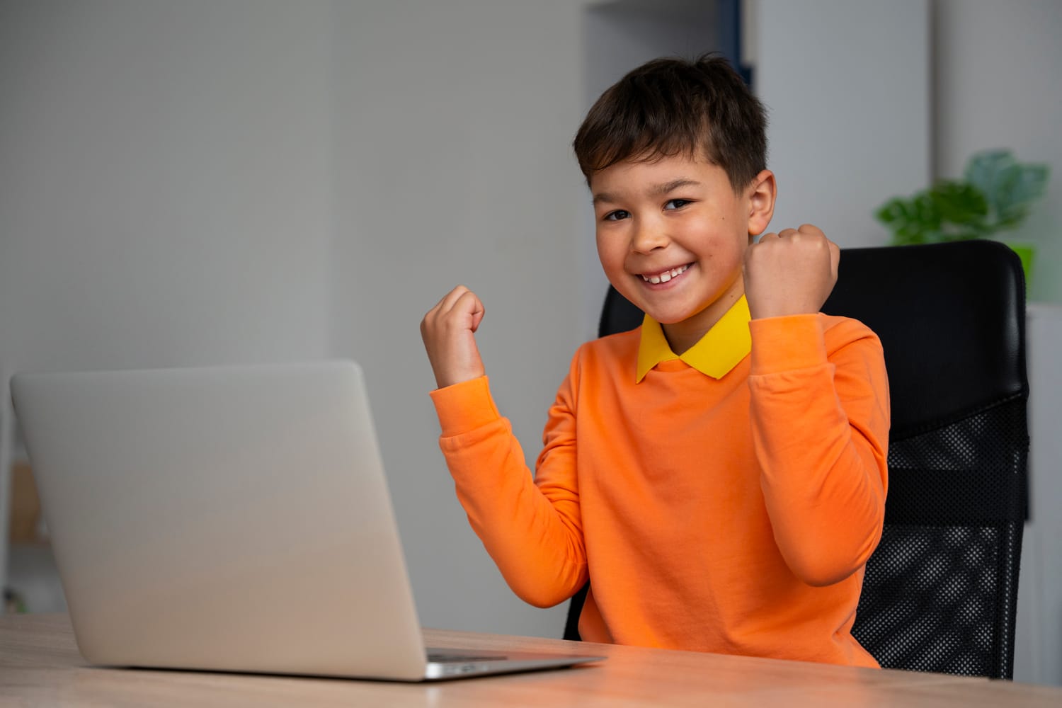 Child celebrating a finished web project - website development course for kids
