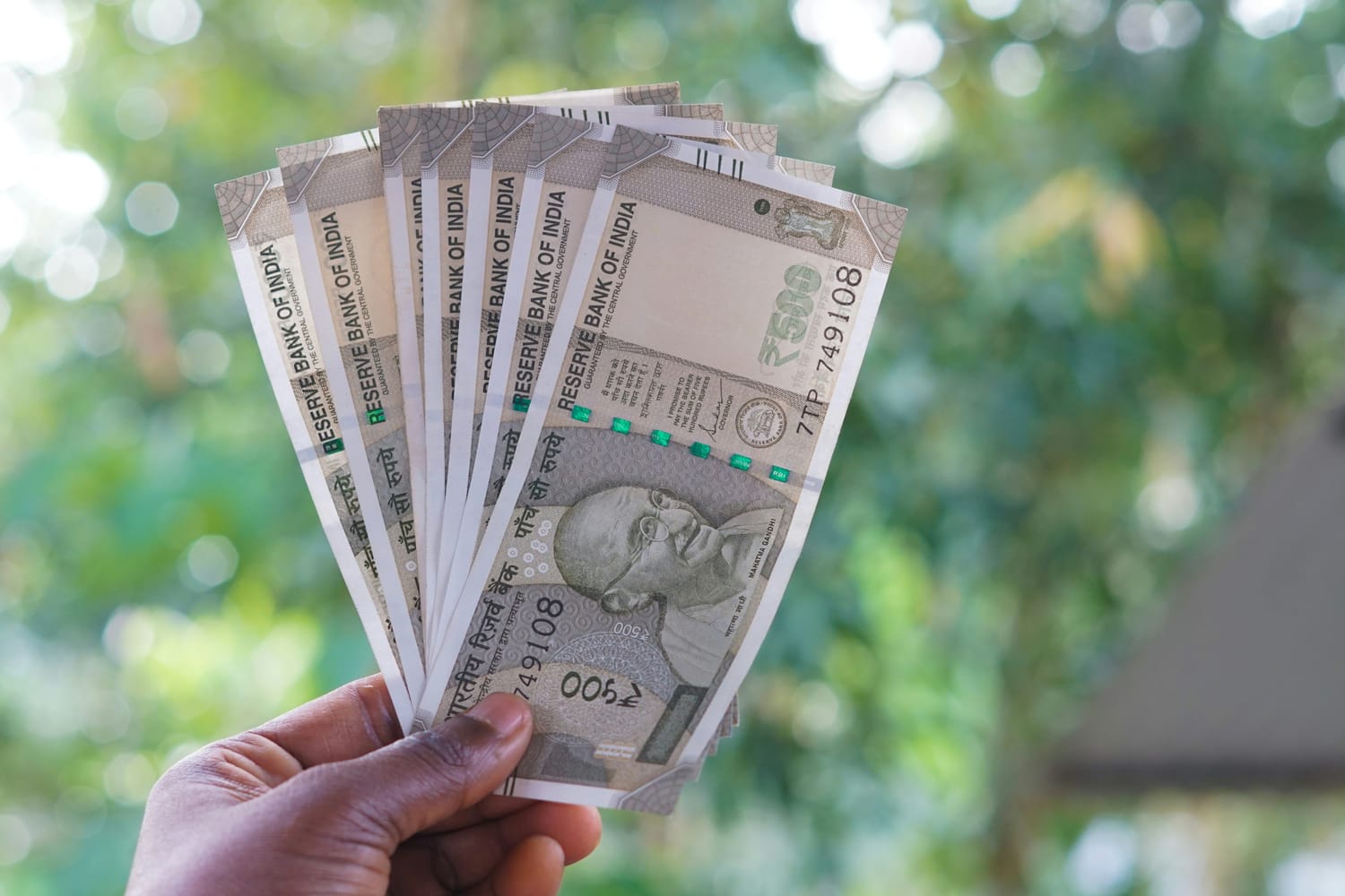 A variety of coins and currency representing different types of tax