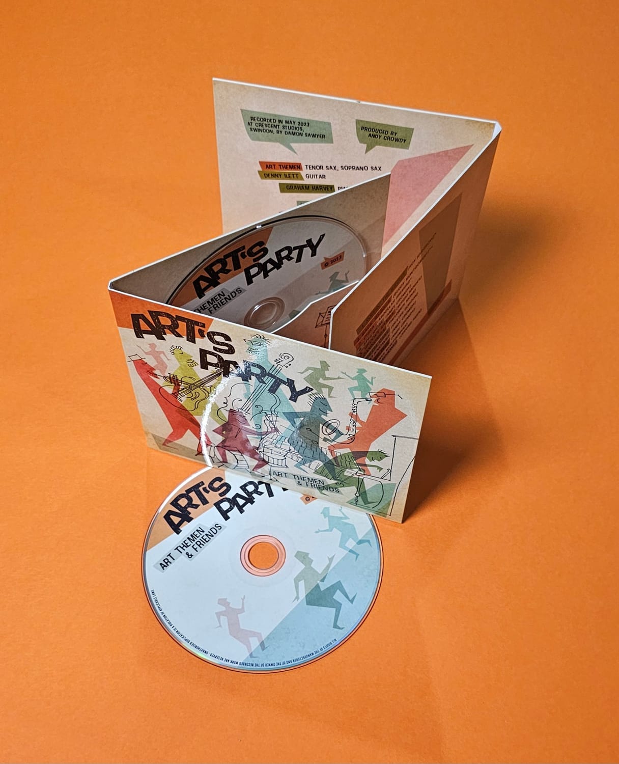 A 6-panel Ecopak CD with full-colour artwork, opened to show the disc