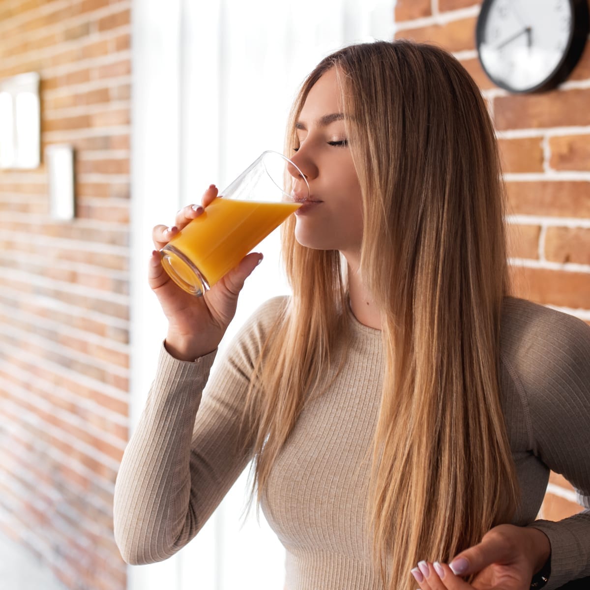 Lifestyle shot of woman drinking Froots Raw Juice – brand marketing